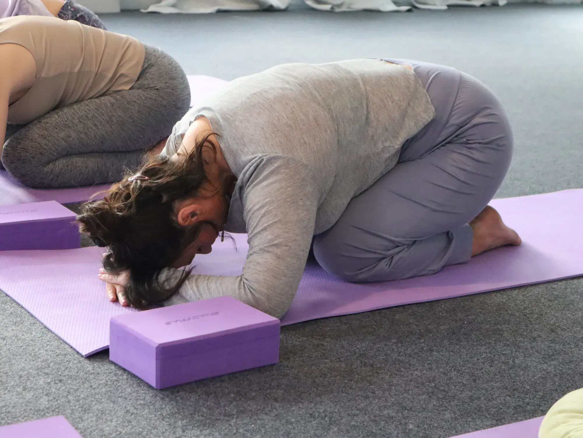 Sound healing retreat in Rishikesh - students resting in Balasana child pose